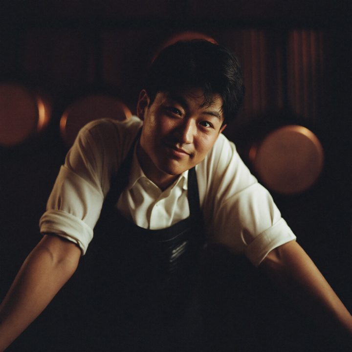 Theo leaning on the pass in a restaurant kitchen after closing